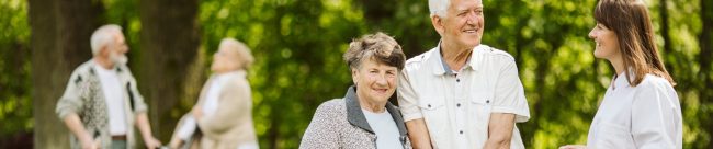 Elder people with the caregiver in the garden