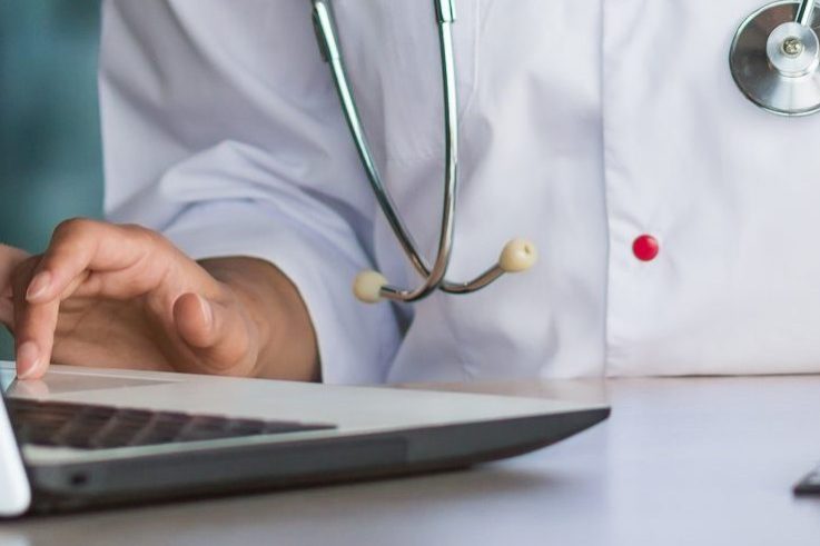 Online training. Young Latin American girl student doctor studies online at home from laptop