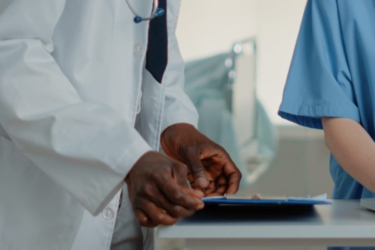 woman-working-as-nurse-using-laptop-to-help-doctor-2022-07-056-13-41-35-utc