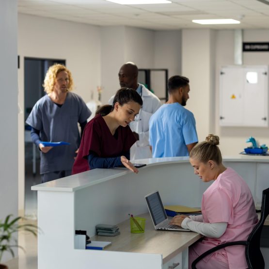 diverse-doctors-talking-at-reception-desk-at-hospi-2025-04-03-16-32-07-utc-min Aged care compliance tools | VCare Software