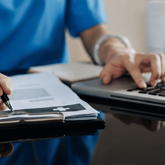 Healthcare professional using laptop with patient data – AI data privacy risk