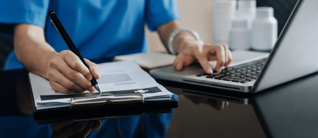 Healthcare professional using laptop with patient data – AI data privacy risk