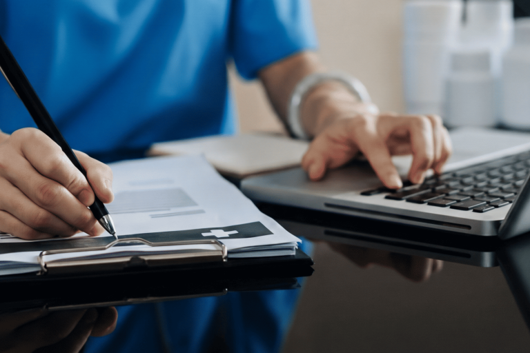 Healthcare professional using laptop with patient data – AI data privacy risk