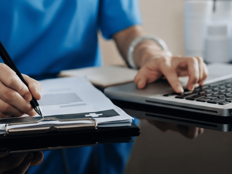 Healthcare professional using laptop with patient data – AI data privacy risk